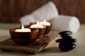 Candles and stones in a calm zen spa environment.
